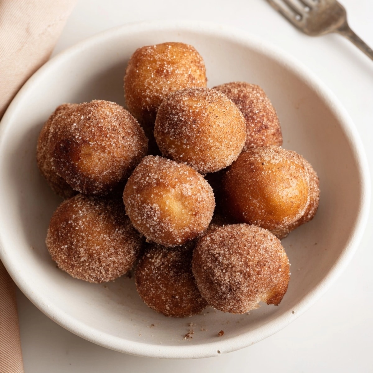 Easy recipe: pillowy Cinnamon Sugar Donut Holes, served warm with coffee—a delicious treat!