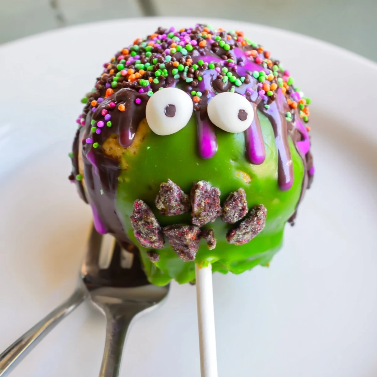 Cheesy Jalapeño Sweet Tea Monster Cake Pops topped with colorful sprinkles and candy eyes.  