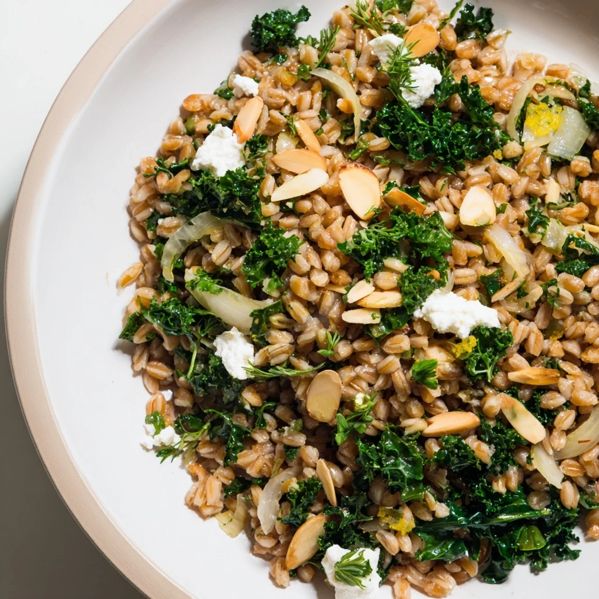 Golden toasted almonds top the warm farro and greens pilaf, a satisfying vegetarian side dish.