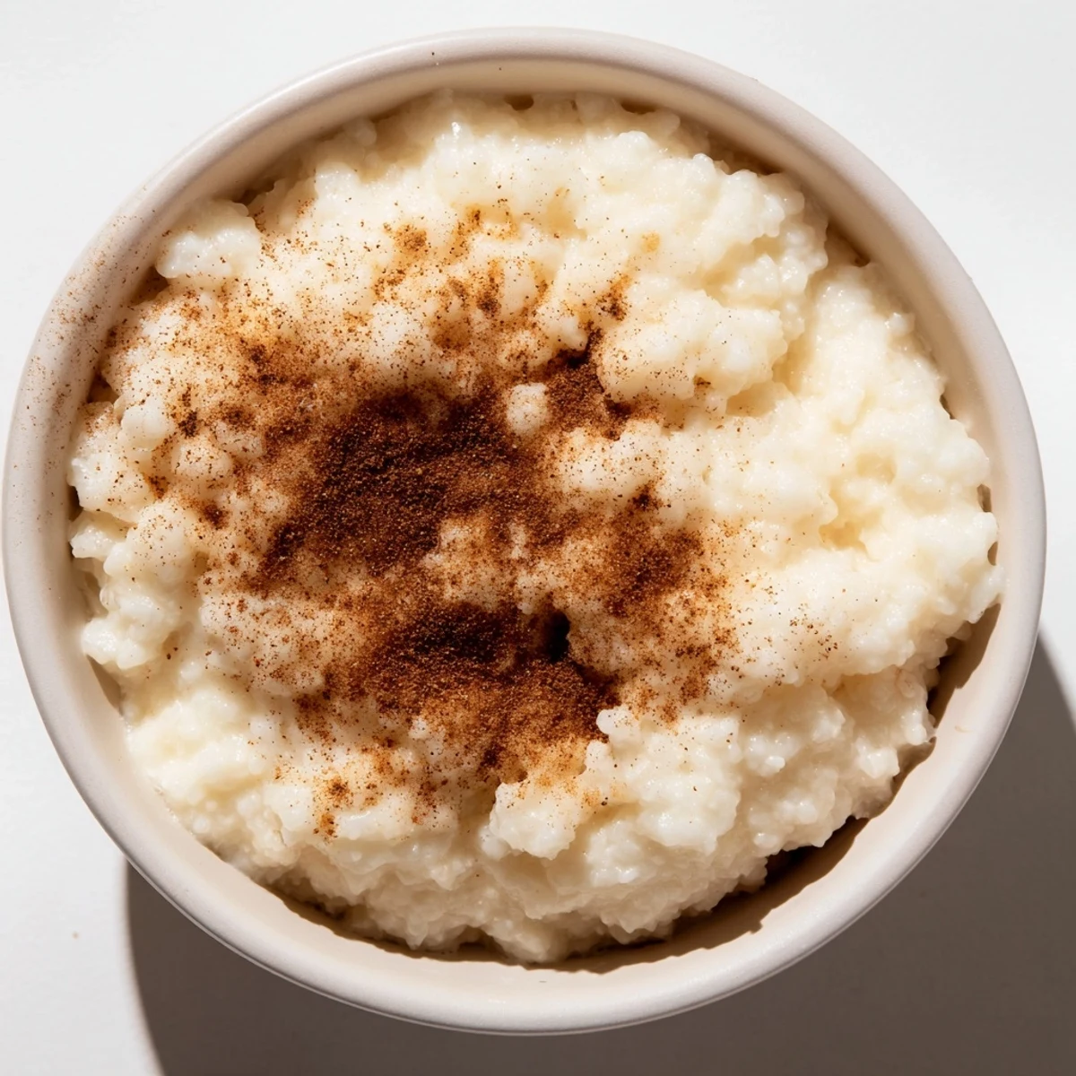 Creamy rice pudding with leftover rice, swirled with cinnamon, perfect for a cozy dessert any time.
