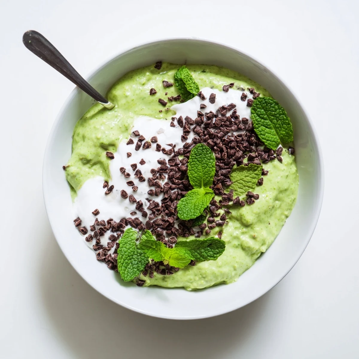 Grinch Green Mint Matcha Breakfast Chia Pudding, layered with creamy yogurt and chocolate chips, ready to enjoy.