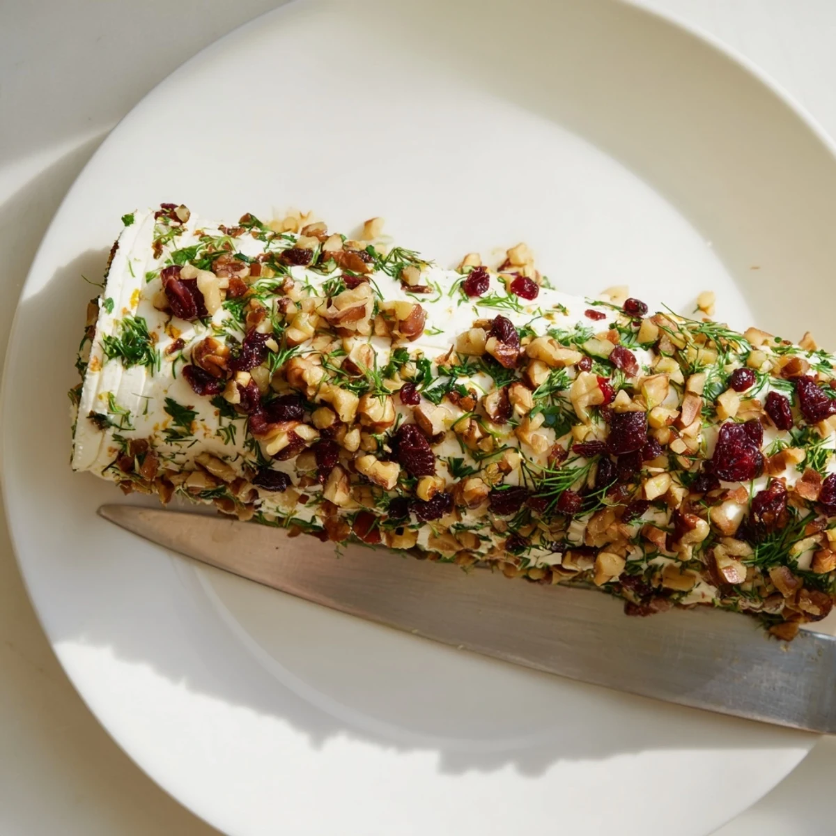 Delectable close-up of the Winter Snowdrift Goat Cheese Log perfect as a gluten-free appetizer presented on a platter.