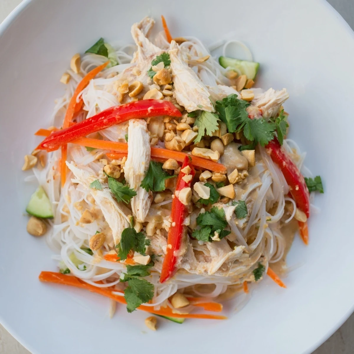Thai-Inspired Peanut Chicken Pasta, a delicious bowl of noodles and vibrant vegetables, ready to eat.
