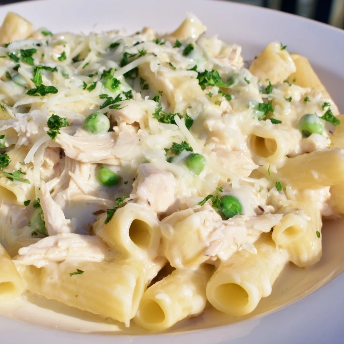 Slow Cooker Chicken Alfredo Pasta Bake: creamy, bubbling pasta and tender chicken, ready to serve.