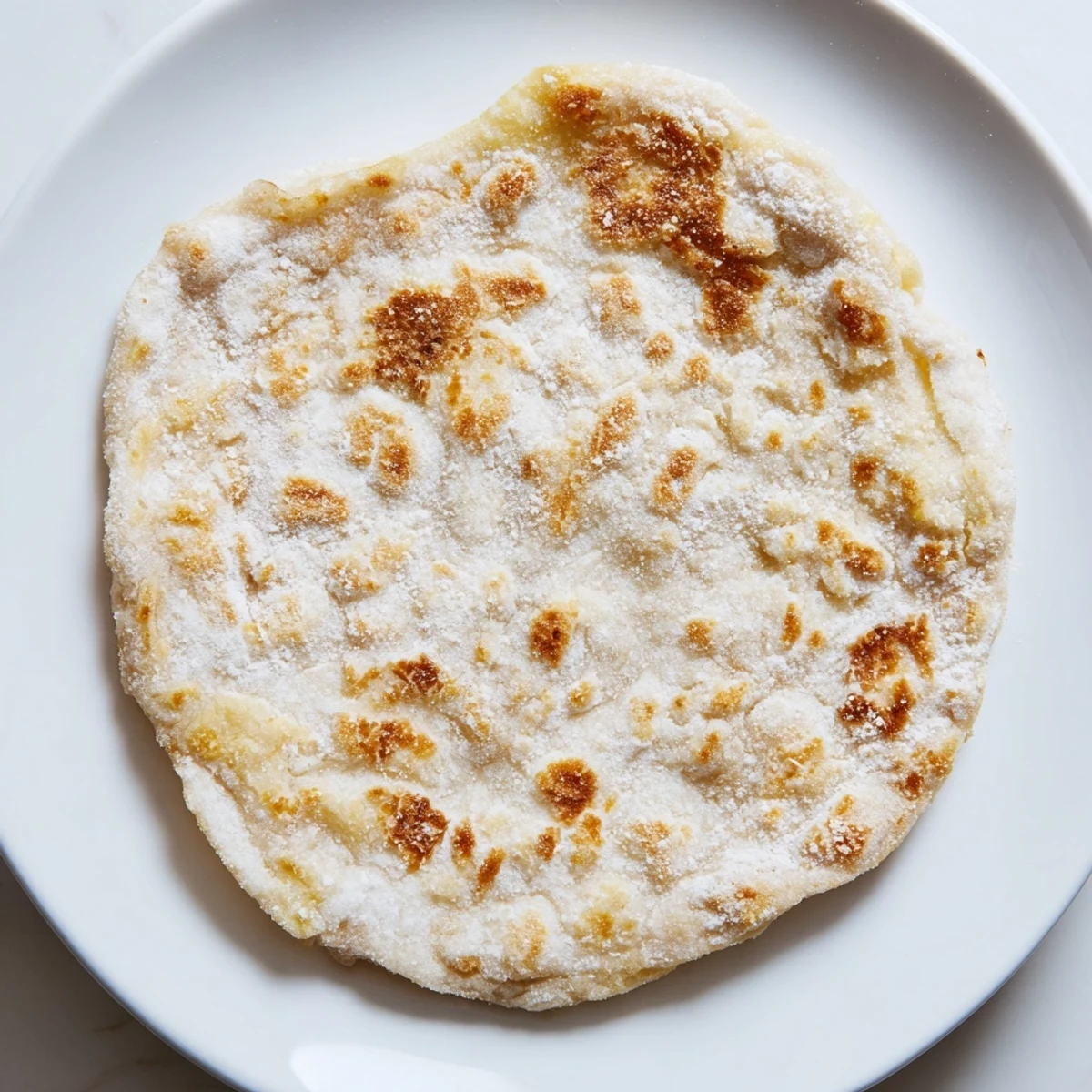 A stack of delicious cottage cheese flatbread, slightly blistered and ready for your favorite toppings.