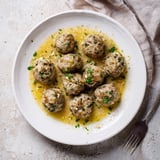 A close-up shot of delicious Instant Pot Greek Meatballs, tender and juicy, topped with a tangy lemon-feta cheese.