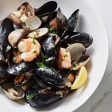 Enjoy a seafood feast with this delectable Shellfish & Seafood Medley, cooked with wine and aromatic flavors.