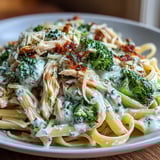 A close-up of High Protein Rotisserie Chicken Broccoli Pasta featuring bright broccoli and juicy chicken in a silky yogurt sauce.