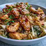 Sizzling ground chicken with garlic and ginger gets tossed with crisp cabbage and shredded carrots for a low-carb dinner. 