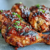 Tender BBQ Chicken Drumsticks coated in a sticky, sweet-spicy peach glaze.