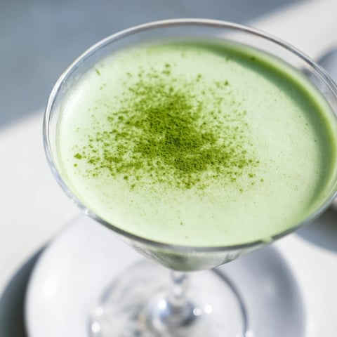 Frothy Matcha Martini, a beautiful green cocktail, chilled beautifully in a martini glass.