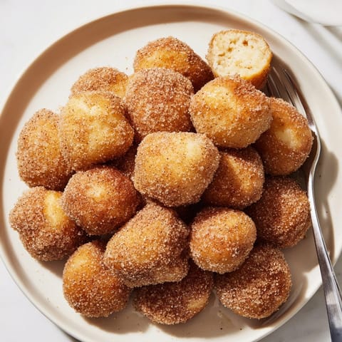 Homemade Cinnamon Sugar Donut Holes cooling; smell the warm sugar and spice in the air.