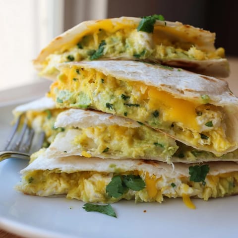 Warm and cheesy Avocado Egg Cheddar Quesadillas: mashed avocado, scrambled eggs, and cheddar heaven.