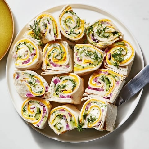Colorful pickle-in-a-blanket snack featuring soft tortillas and zesty dill pickles.  