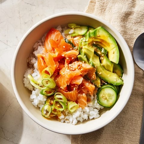 Flavorful leftover salmon and rice bowl, garnished with sesame seeds and pickled ginger.  