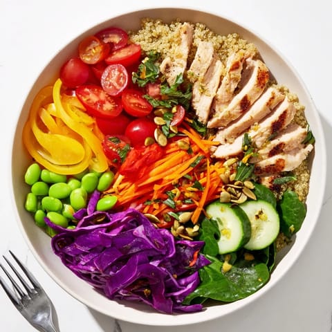 Colorful Healthy Meal-Prep Bowls with quinoa, fresh vegetables, and zesty dressing drizzled.  