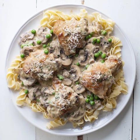Creamy Chicken Alfredo Slow-Cooker Dump Meal swimming in a rich, velvety Alfredo sauce, perfect for pasta.