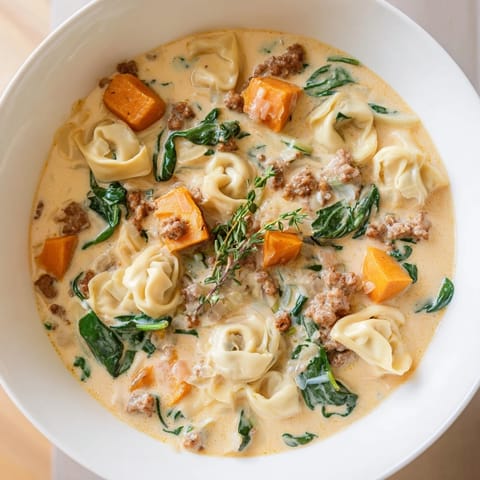 Golden, creamy broth around tender tortellini in this delicious sausage tortellini soup recipe.