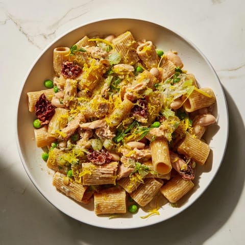 Vibrant image of a rich Healthy Tuscan White Bean & Kale Christmas Pasta, full of kale and cherry tomatoes.