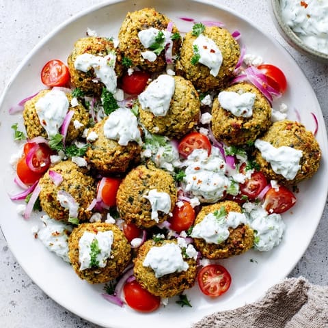 Golden-crisp falafel nestled in a wreath arrangement, a Festive Falafel & Tzatziki Christmas Wrap.