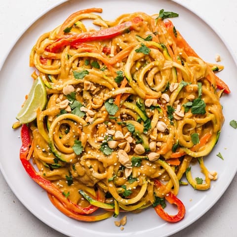 Freshly tossed Zesty Peanut Zucchini Noodles: a refreshing salad with peanuts and bright flavors.