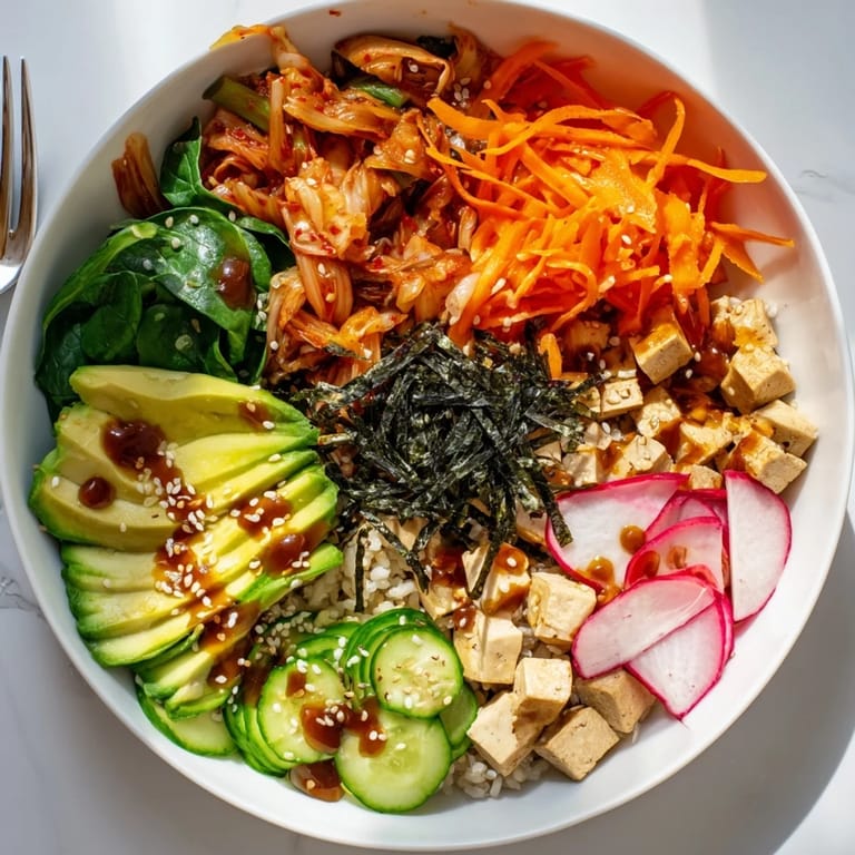 Vibrant fermented vegetable bowl featuring tangy kimchi, grains, and fresh veggies.  