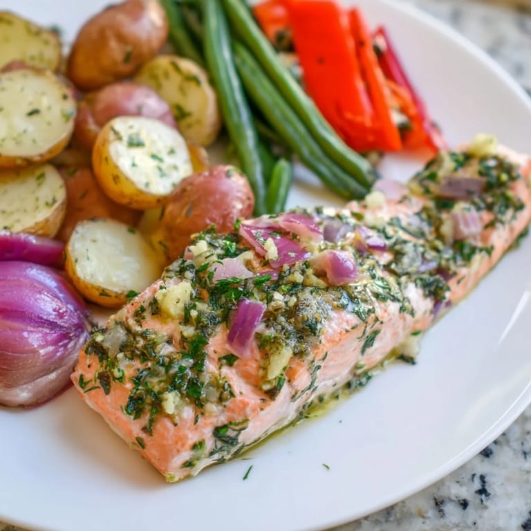 Fragrant Lemon Herb Salmon & Potato Sheet Pan, a complete meal, fresh from the oven, glistening.