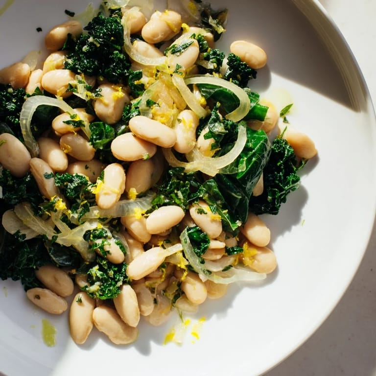 This rustic dish of Garlicky Beans with Winter Greens looks delicious, perfect for a cozy, flavorful meal.
