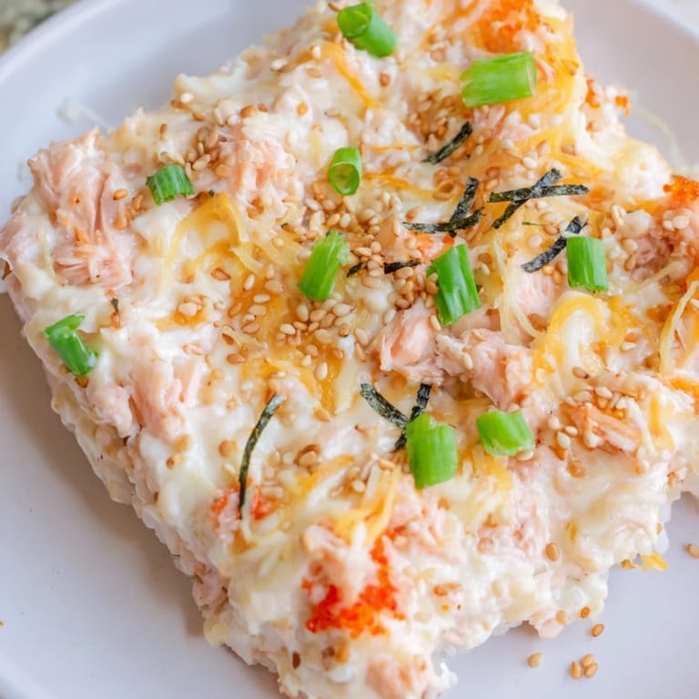 A close-up view of a baked Creamy Salmon Sushi Bake showcasing the creamy texture and delicious flavors.