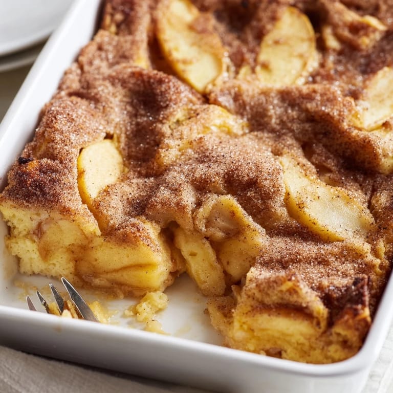 Moist Baked Apple Cake with spiced apples baked into a golden cake, perfect with crème fraîche or vanilla yogurt.